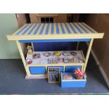 A dolls house fishmongers market stall with sign and wares.