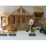 A dolls house garden set comprising shed, orangery and greenhouse,