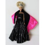 A Special Edition Barbie doll in black and silver dress.