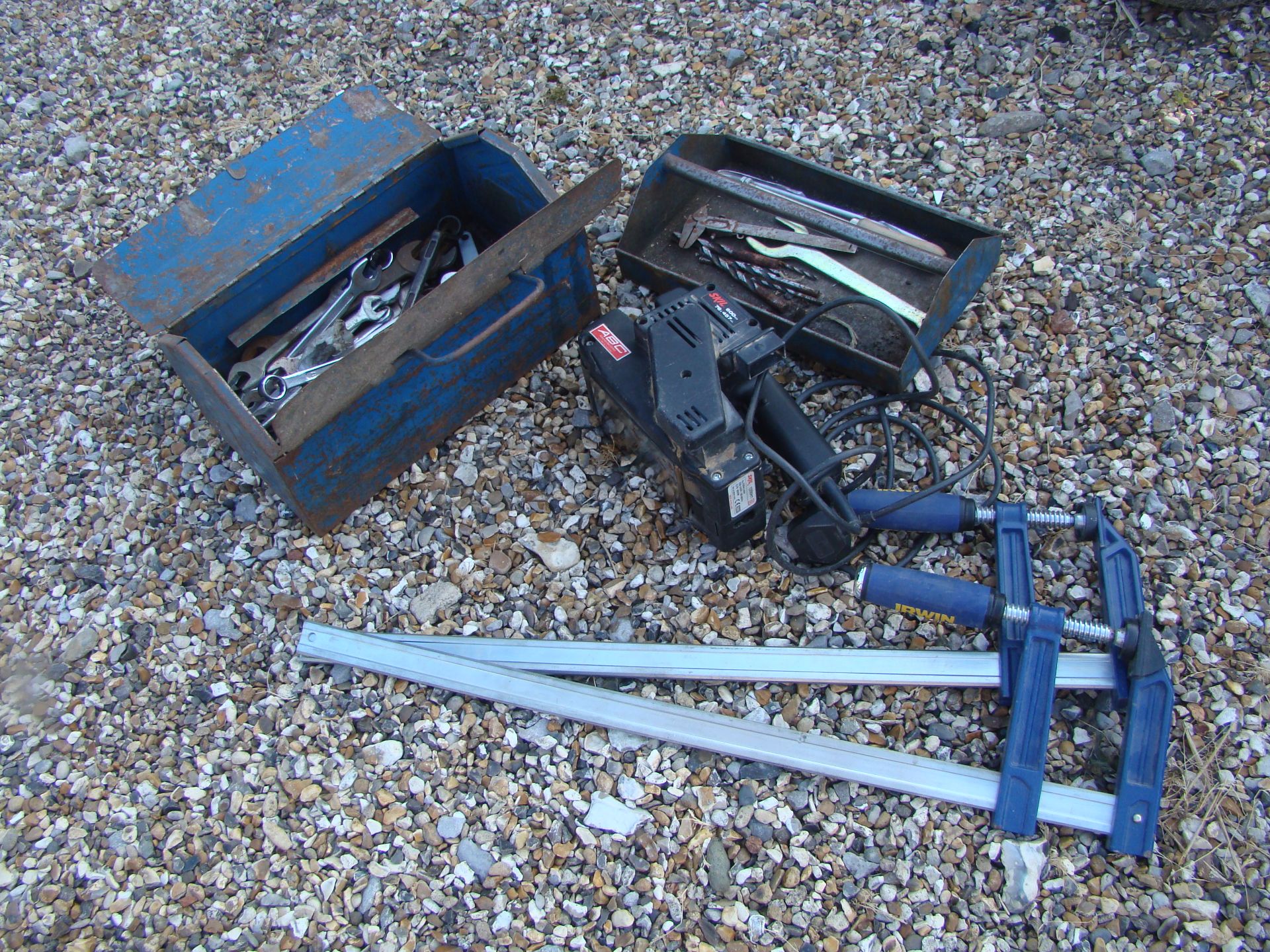 A metal tool box containing a large quantity of metric and imperial spanners including English made,