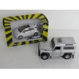 A die cast scale model Fiat 500 by Cararama 1:43 scale together with a Landrover Defender in silver.