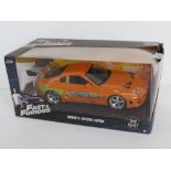 A die cast Fast & Furious Toyota Supra scale model in original packaging.