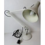 A white metal angle poise type desk lamp.