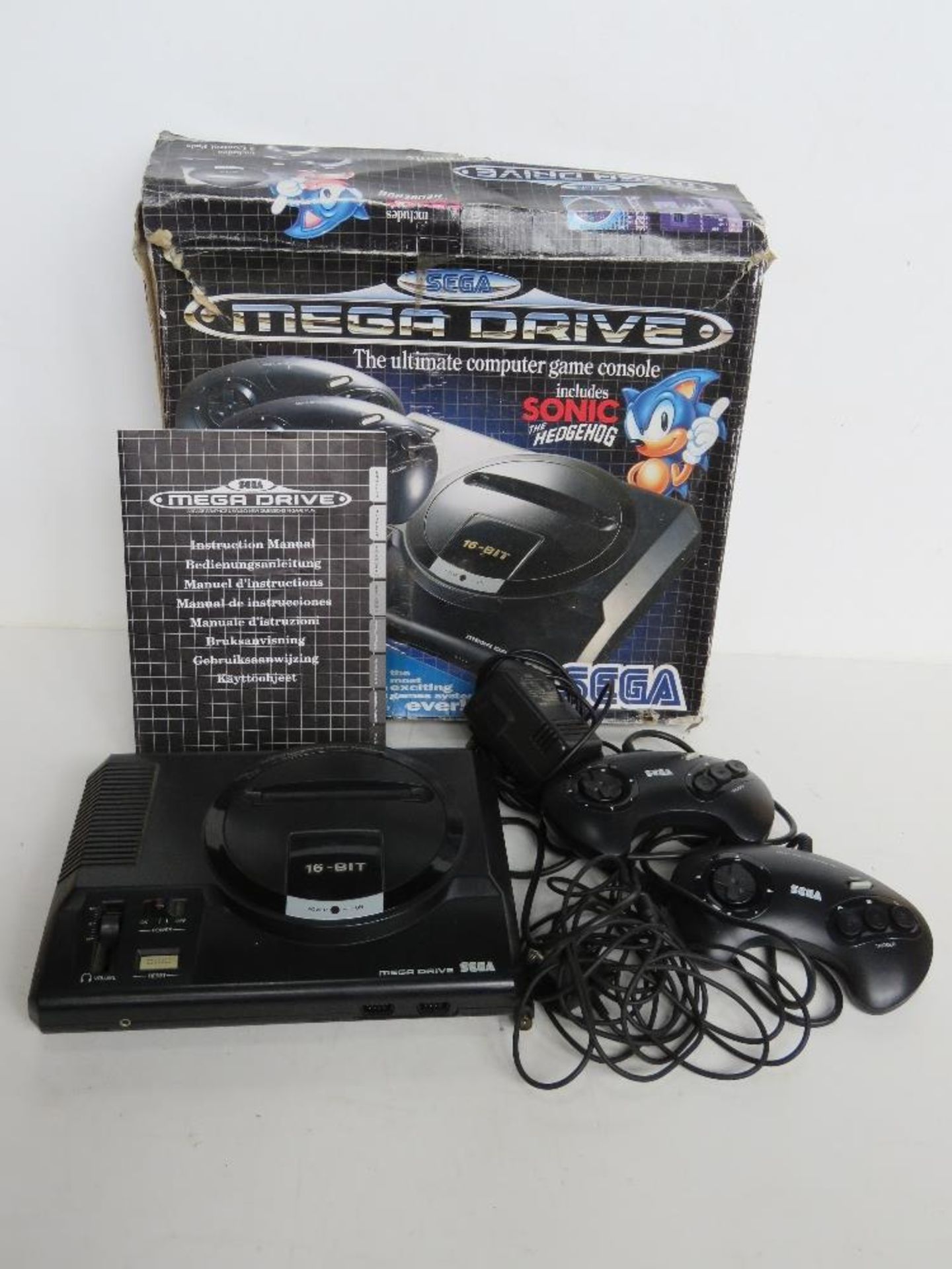 A Sega Mega Drive with instructions, cable and controllers in original box, box a/f.