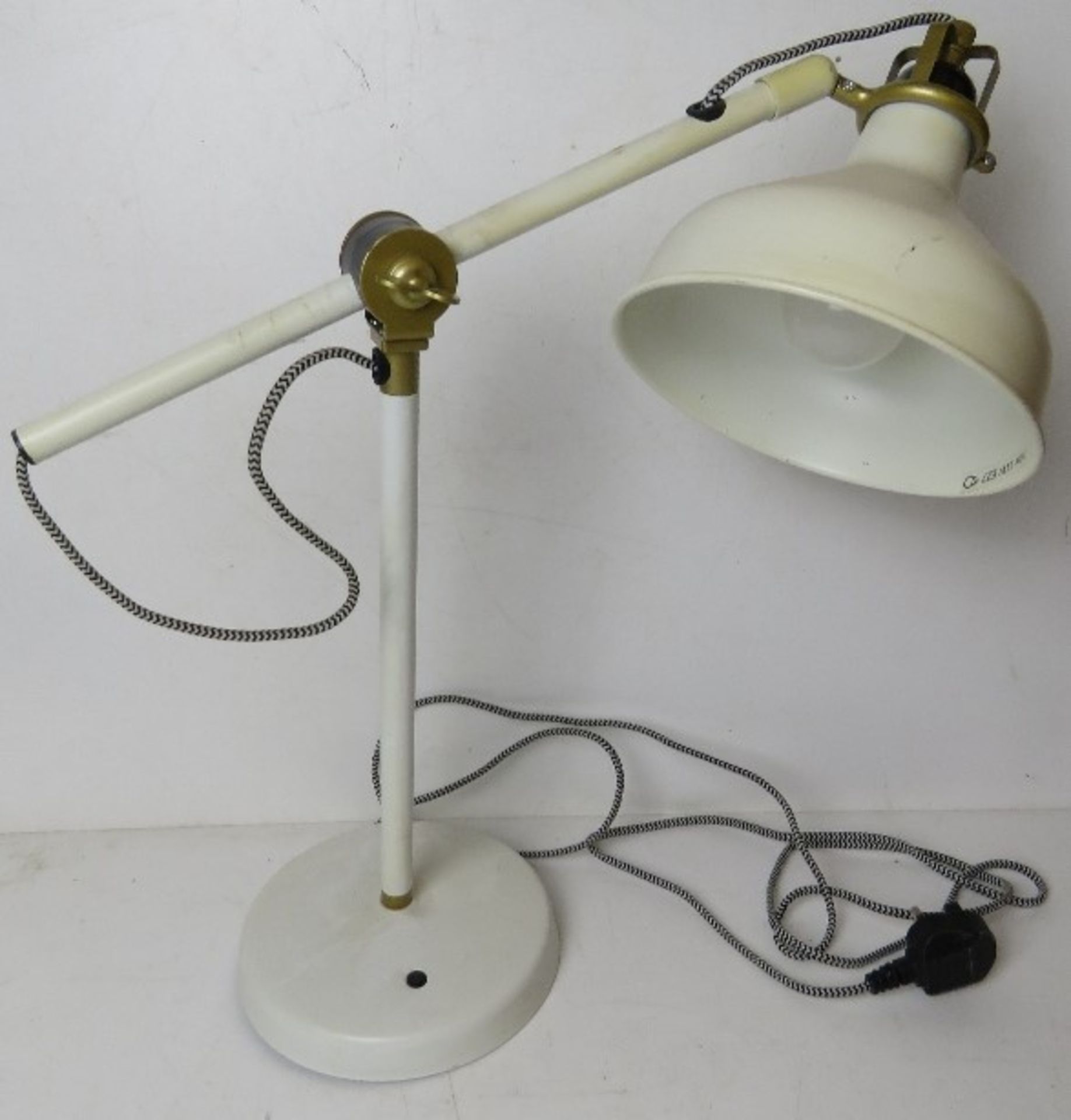 A white painted metal contemporary angle poise style table lamp.