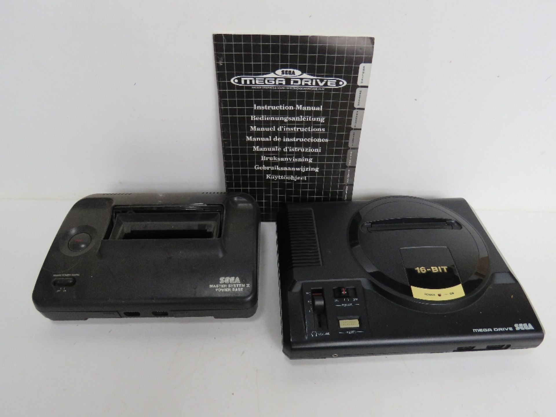 A Sega Mega Dive with instructions, together with a Sega Master System II Power Base, no cables.