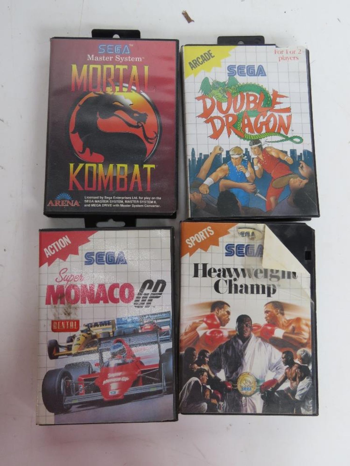 Four Sega game cartridges including Mortal Kombat Disclaimer - all items in this sale are sold as