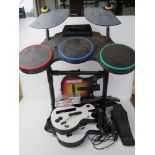 A Wii Rockband being drumset, guitar, base, etc, inc three Guitar Hero games.