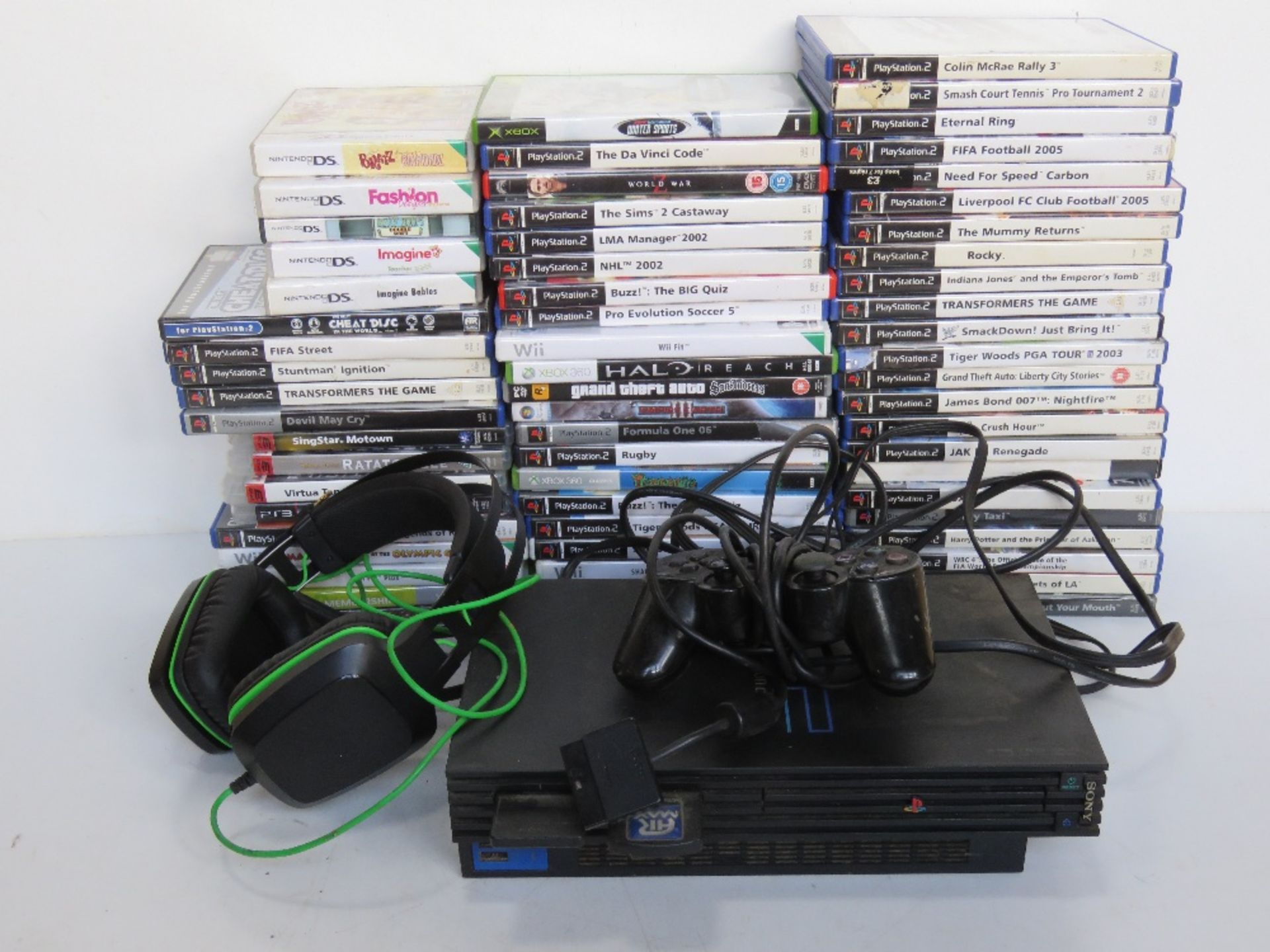 A PS2 with controller and assorted video games including some Nintendo DS, Wii and Xbox.