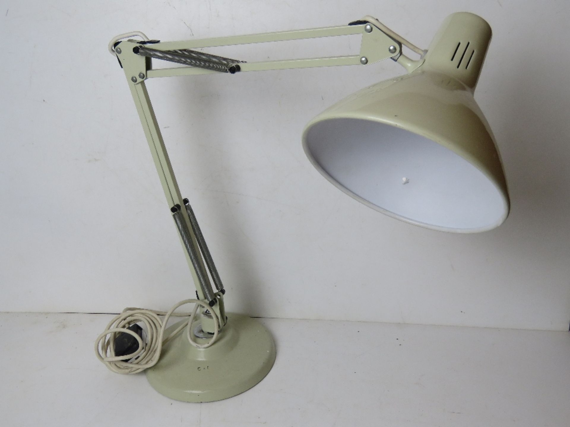 A white painted metal angle poise style table lamp.