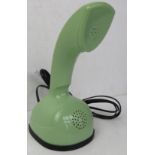 A contemporary avocado green push button Rotary style telephone.