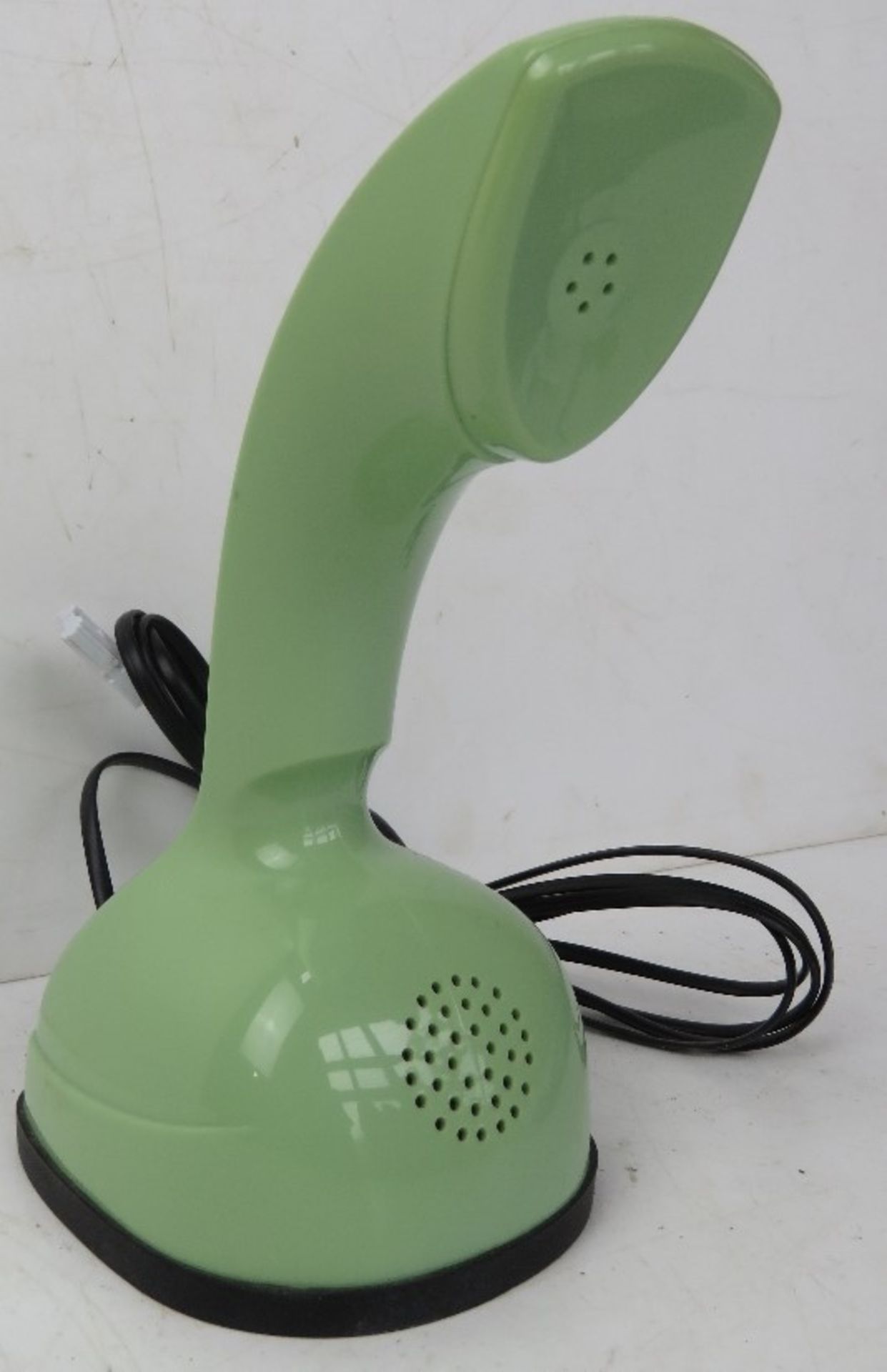 A contemporary avocado green push button Rotary style telephone.