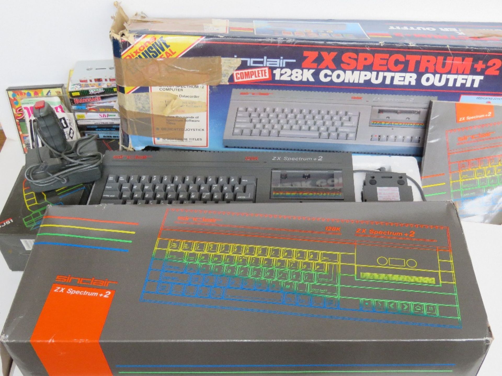 A Sinclair ZX Spectrum +2 with controller and games in original box, boxes showing signs of wear,