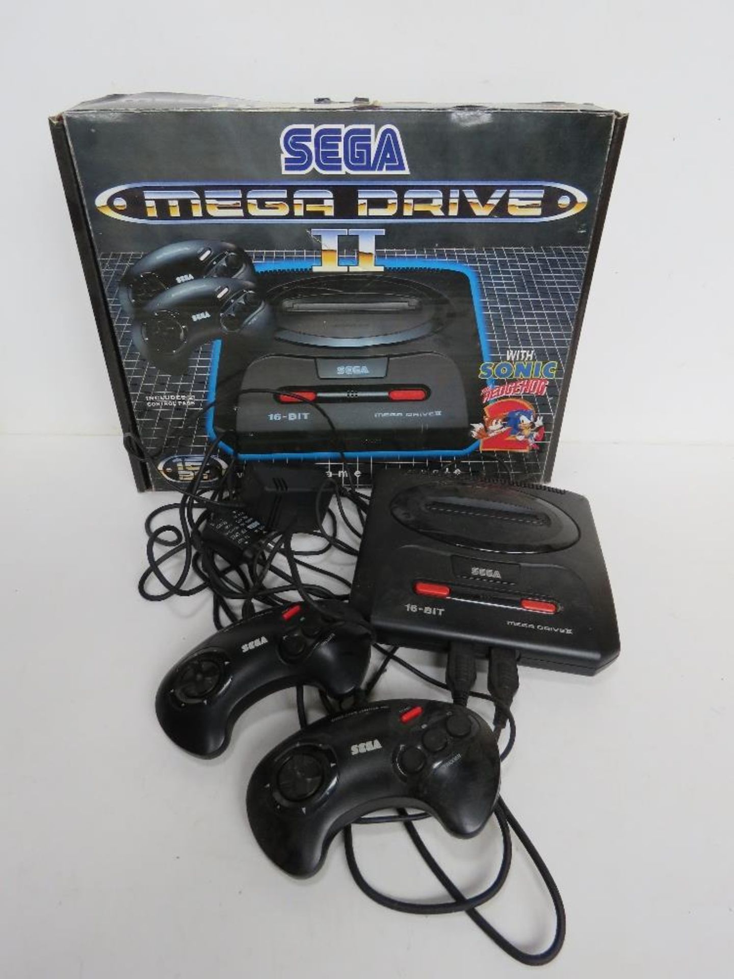 A Sega Mega Drive II console with controllers and cable in original box.