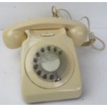 A contemporary cream coloured Rotary telephone.