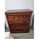 A Victorian mahogany chest of two short over three long drawers, turned wooden handles,