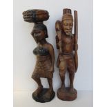 Two large wooden African carvings of a man and woman each standing approx 62cm high.