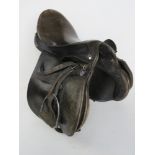 A black leather saddle by Berkeley inc stirrups, size 18 3/4".