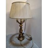 A large contemporary brass three-sconce table lamp complete with cream silk shade,