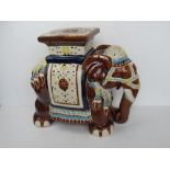 A late 20thC ceramic plant stand in the form of an elephant, approx 45cm high.