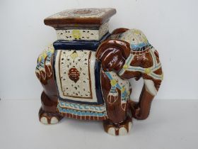 A late 20thC ceramic plant stand in the form of an elephant, approx 45cm high.