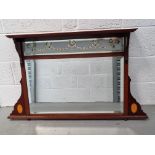 A delightful Edwardian wall mirror having inlaid and coloured decoration to glass and frame.