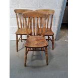 A set of three dining chairs, naive restoration noted.