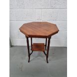 An octagonal occasional table with square undershelf raised over shaped legs.