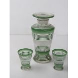 An Art Deco decanter with matching pair of tot cups, decanter standing 22.5cm high.