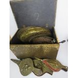A brass covered log box containing fireplace tongs,