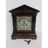 A JB Yabsley London mantle clock in good architectural frame opening to reveal pendulum and key