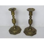 A pair of brass candlesticks having once been converted for use as lamps.