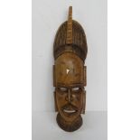 A hand carved tribal wall mask approx 57cm in length.