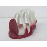 A Carltonware Australian design toast rack in pink.