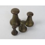A set of four brass graduated weights by Avery; 7lb, 4lb, 2lb & 1lb.