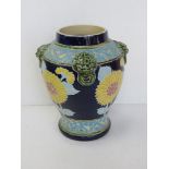 A large part glazed Majolica vase having sunflower design with relief vine design and dragons head