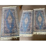 Three (2+1) matching Royal Keshan 100% wool rugs, in blue ground, one measuring 83 x 160cm,