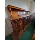 An impressive Gothic Revival carved oak buffet or sideboard, four doors,