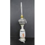 A large late 19th century French ceramic and chrome oil lamp with glass chimney having classical