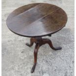 A delightful oak foldover occasional table raised over 3 shaped outswept legs 59cm diameter 55cm