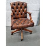 A Chesterfield type office chair on castors.