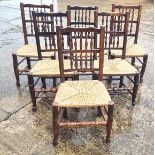 A set of six cane seated dining chairs having spindle bobbin turned backs.
