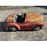 A vintage Austin J40 pedal car in barn find condition.