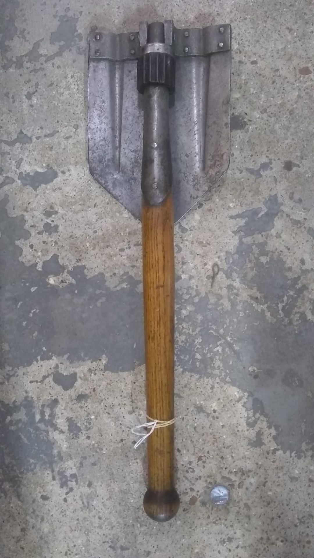 A WWII German folding entrenching tool. This lot will be available to collect in person 48 hours