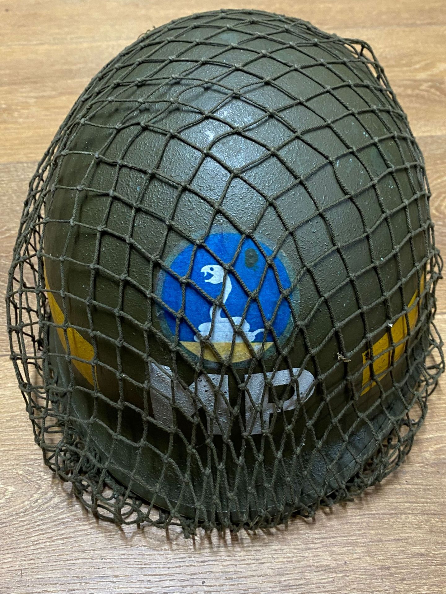 A US M1 military police helmet with a Vietnam era liner, modern decals, with netting and chin strap. - Image 2 of 5