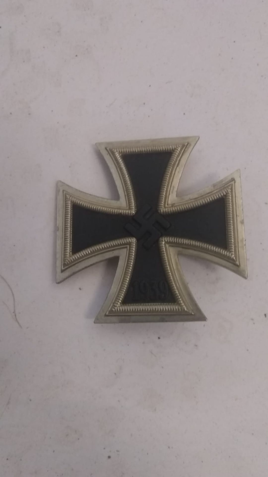 A WWII German iron cross badge bearing mark to pin. This lot will be available to collect in