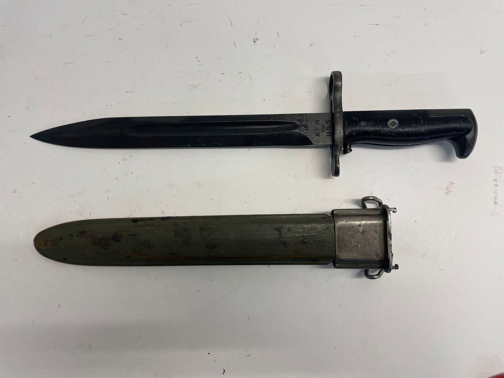 A WWII American M1 Garand bayonet with scabbard. This lot will be available to collect in person