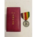 A WWII Japanese showa enthronement commemorative medal in box.