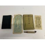WWII Japanese books together with a pipe and paper money, one of the books being a technical manual.