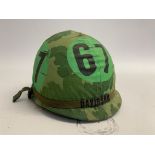 A US M1 airborne training helmet with embroidered band bearing the name Davidson.